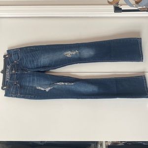 Dark wash size 0 jeans with fitted thigh and slight flare at ankle.